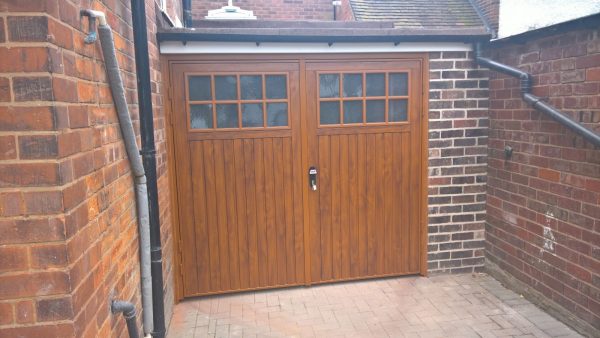 Installed side hinged wooden garage doors