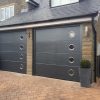 two black sectional garage doors with windows