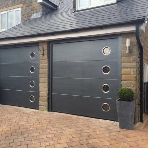 two black sectional garage doors with windows