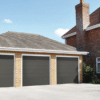 triple grey electric garage doors