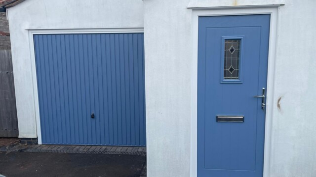 White house with matching blue front door and garage door