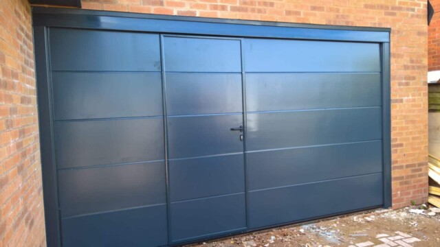 grey sectional garage door with pedestrian access