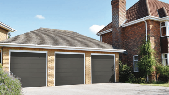 triple grey electric garage doors