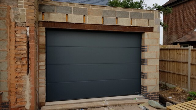 garage with no garage door prior to installation